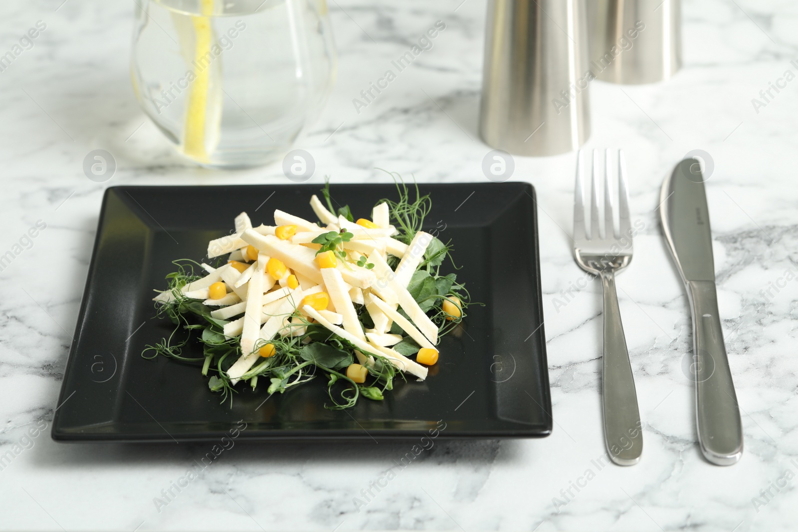 Photo of Delicious carrot salad served on white marble table