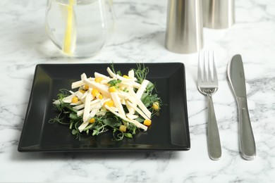 Photo of Delicious carrot salad served on white marble table