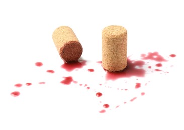 Bottle corks with wine stains on white background