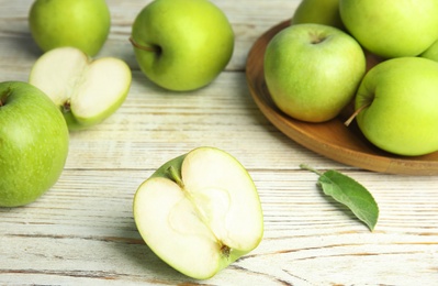 Photo of Fresh ripe green apples on white wooden table