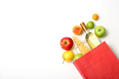 Flat lay composition with shopping bag and products on white background