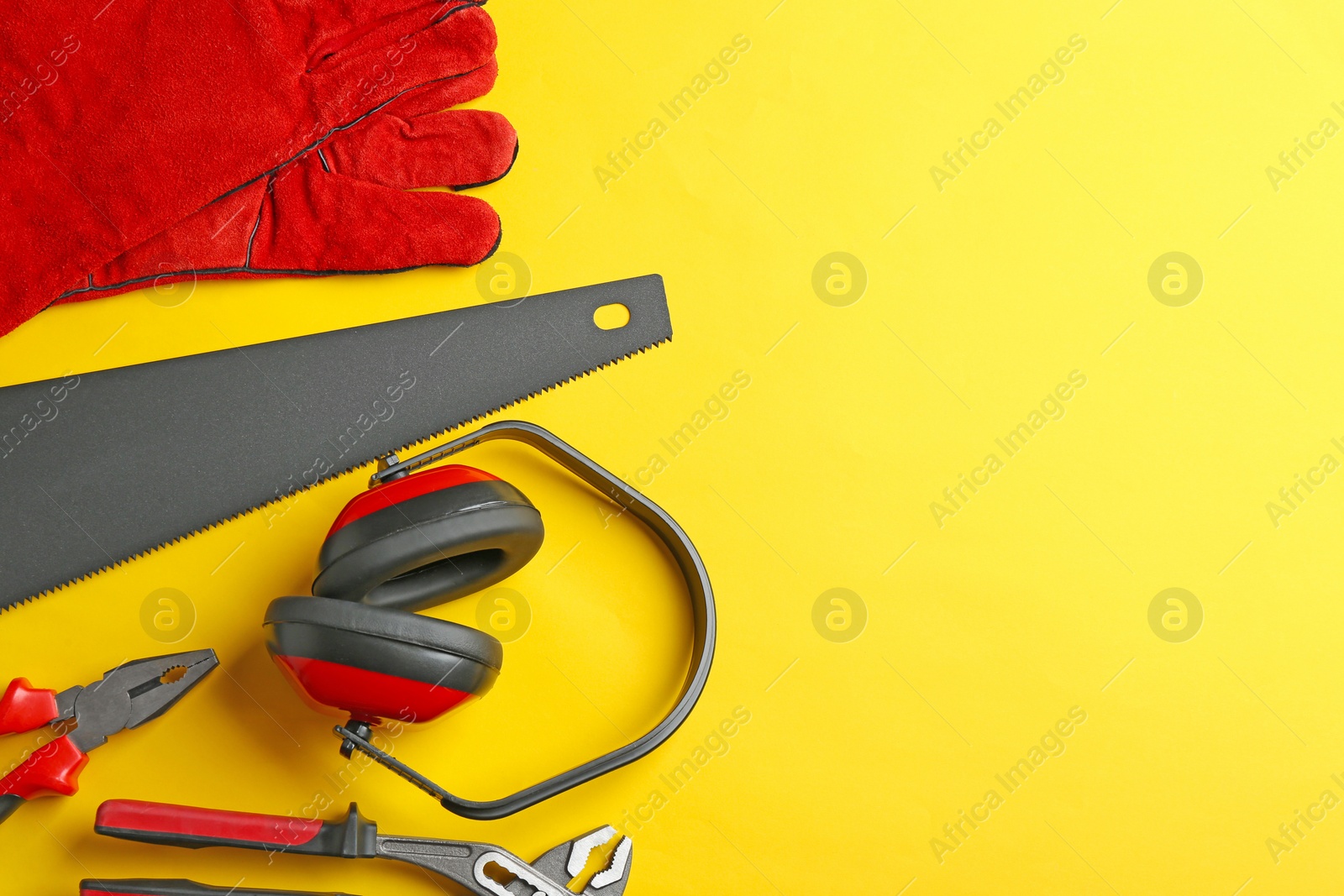 Photo of Flat lay composition with different construction tools and space for text on color background