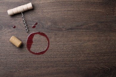 Photo of Wine stain, corkscrew and stopper on wooden table, flat lay. Space for text