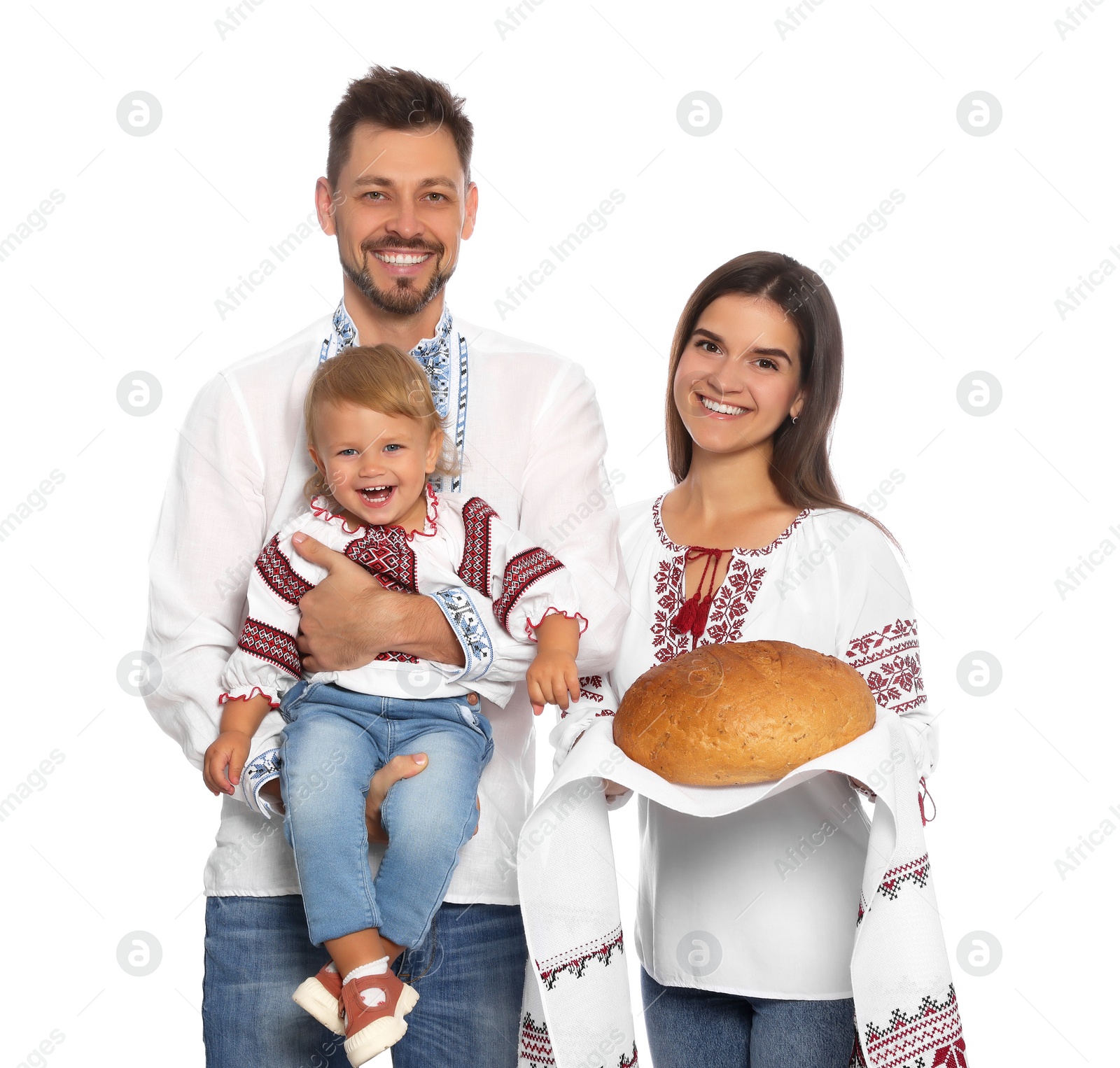 Photo of Happy Ukrainian family in embroidered shirts with korovai bread on white background