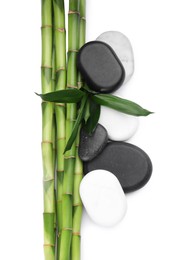 Photo of Spa stones and bamboo on white background, top view