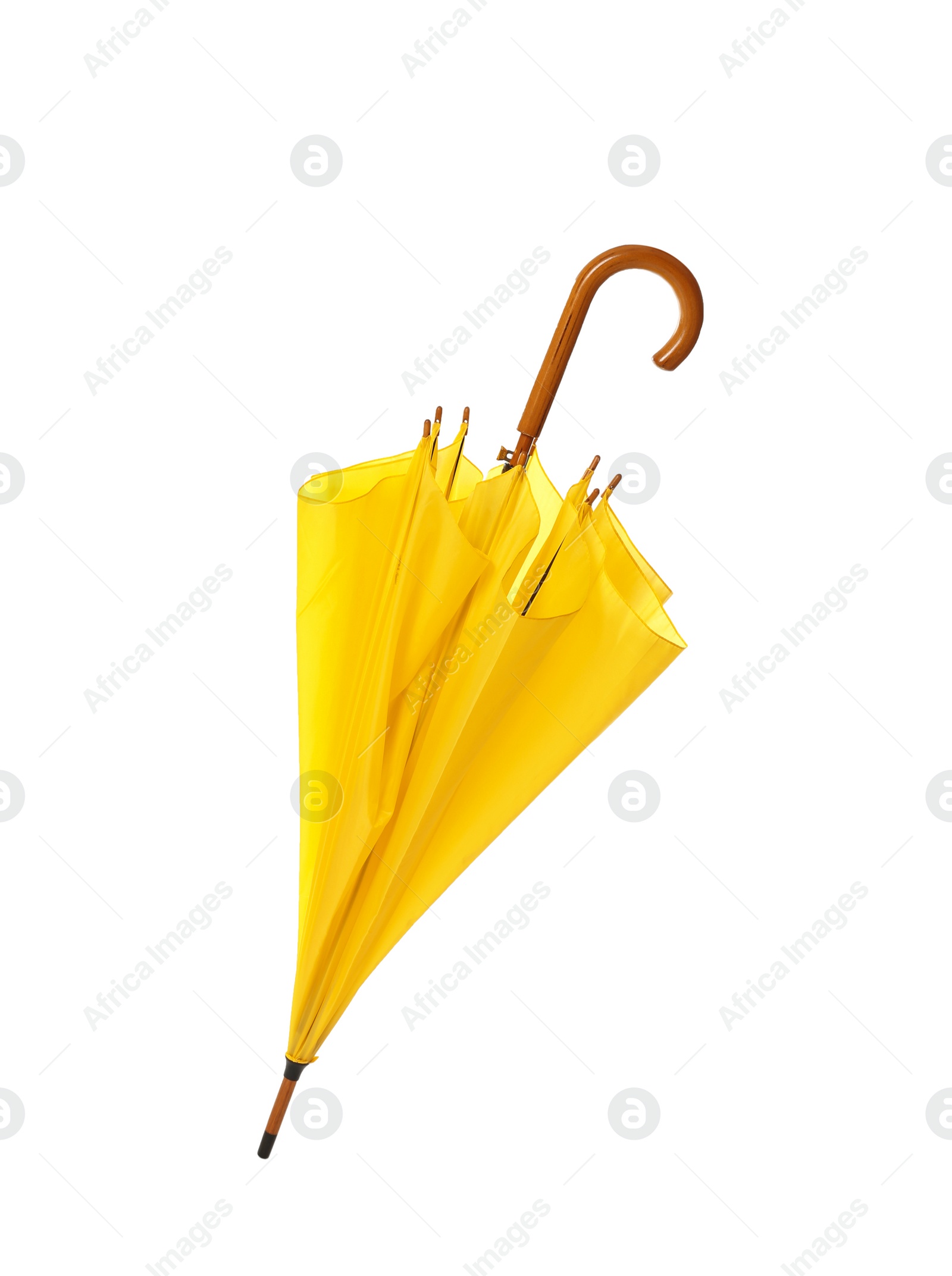 Photo of Modern closed yellow umbrella isolated on white