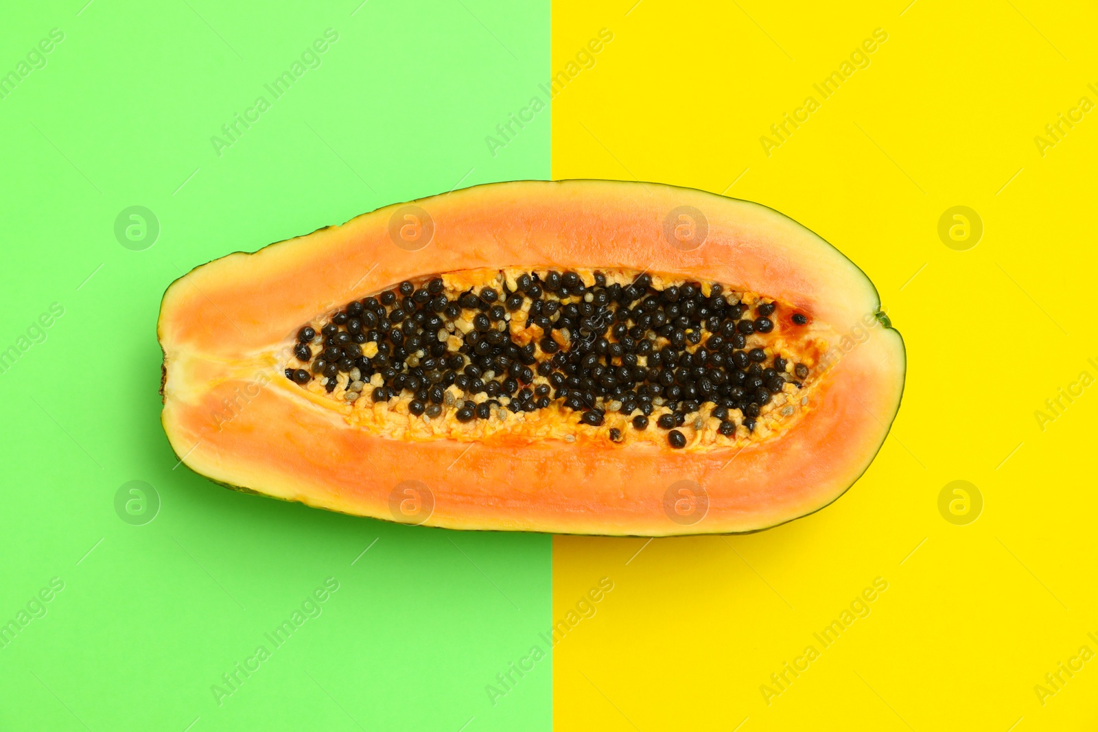 Photo of Fresh juicy halved papaya on color background, top view