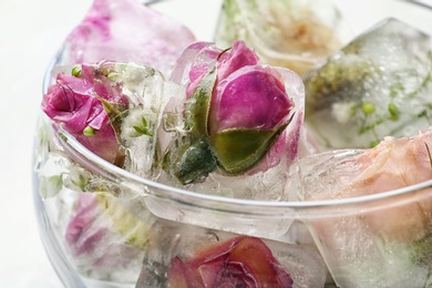 Photo of Glass with floral ice cubes and water, closeup