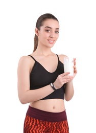 Photo of Beautiful young woman in sportswear drinking milk on white background