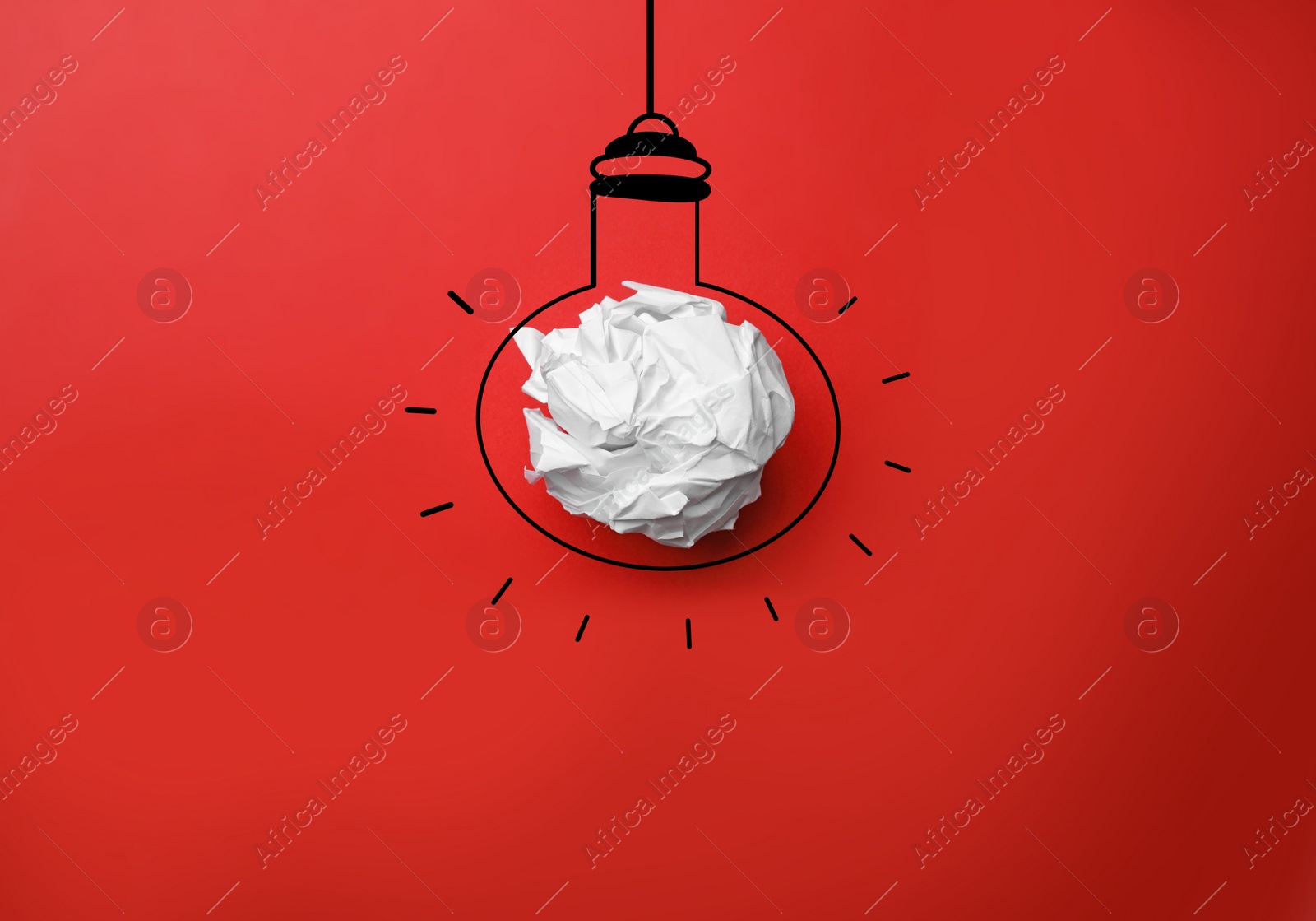 Image of Idea. Illustration of light bulb around crumpled paper ball on red background, top view