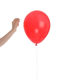 Photo of Woman piercing red balloon on white background