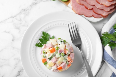 Photo of Delicious salad Olivier on table, flat lay