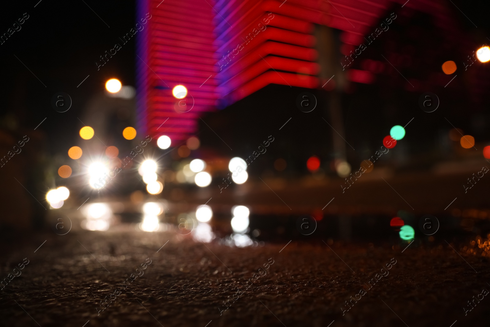 Photo of View of cityscape with bokeh effect, focus on asphalt. Night life