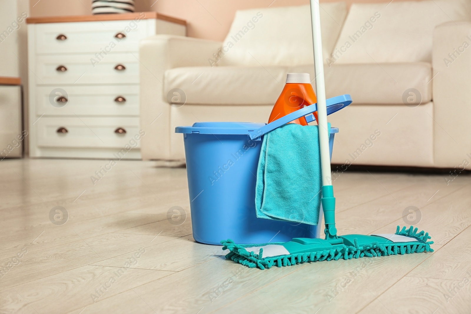 Photo of Cleaning supplies on floor in living room. Space for text