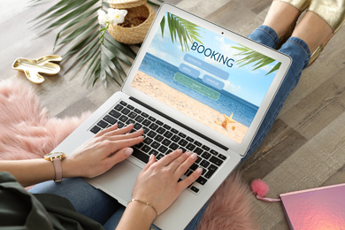 Image of Woman using laptop to plan trip, closeup. Travel agency website