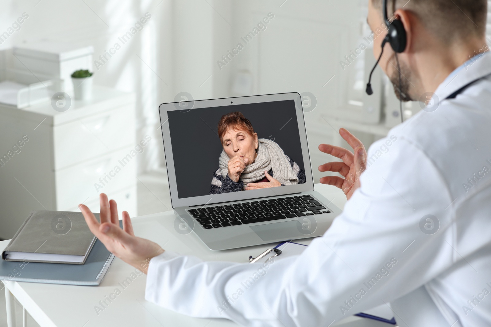 Image of Hotline service. Doctor consulting patient online via laptop indoors