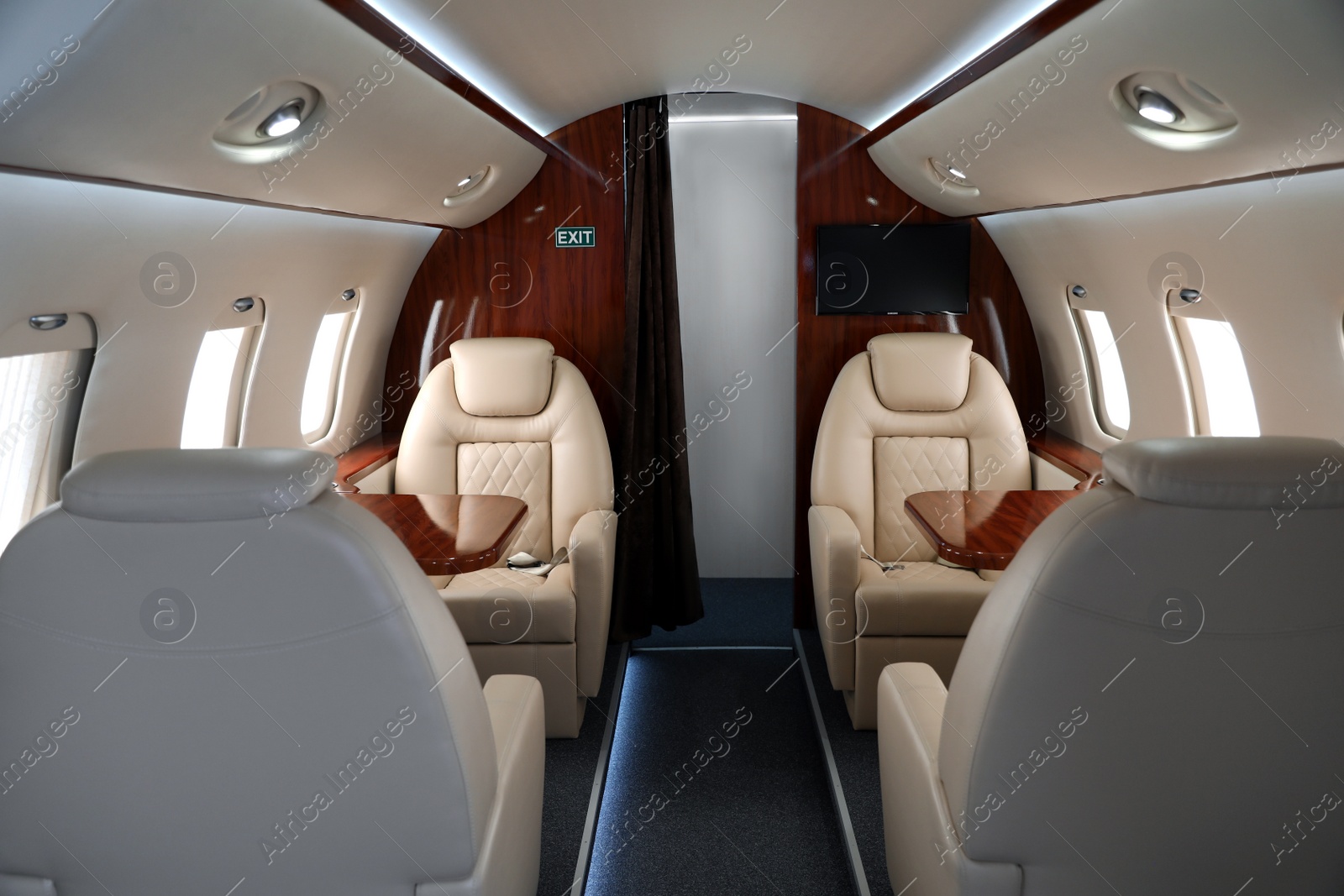 Image of Airplane cabin with comfortable seats and tables