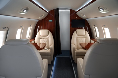 Image of Airplane cabin with comfortable seats and tables