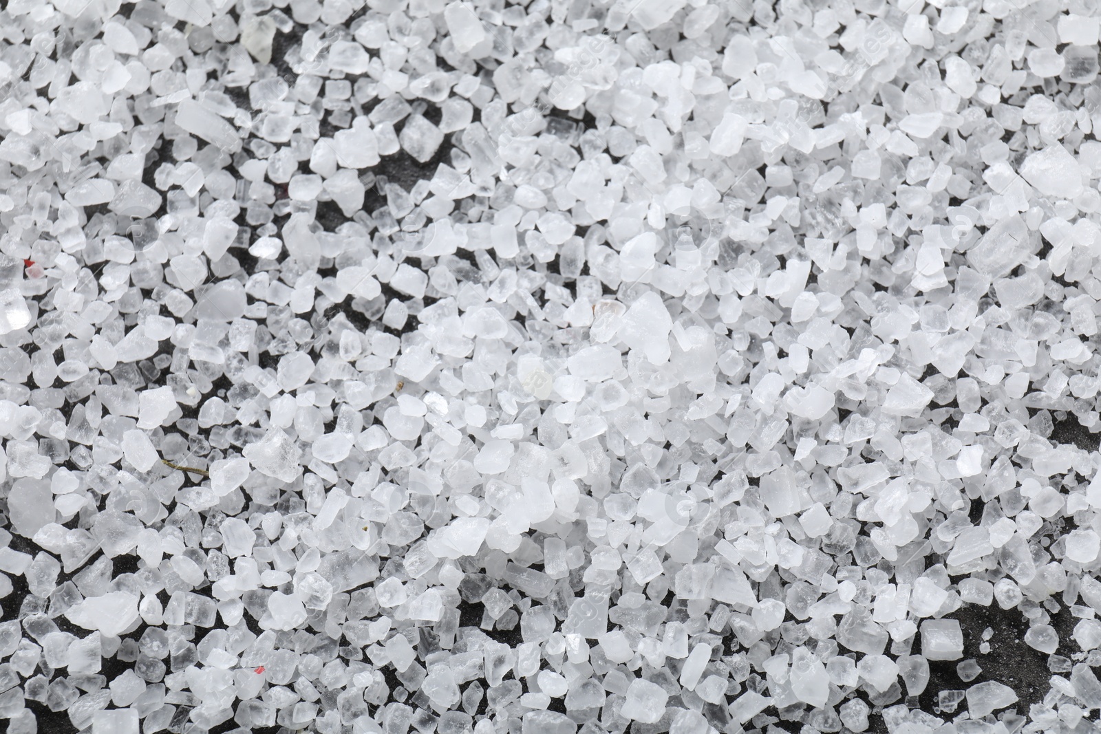 Photo of White natural salt as background, top view