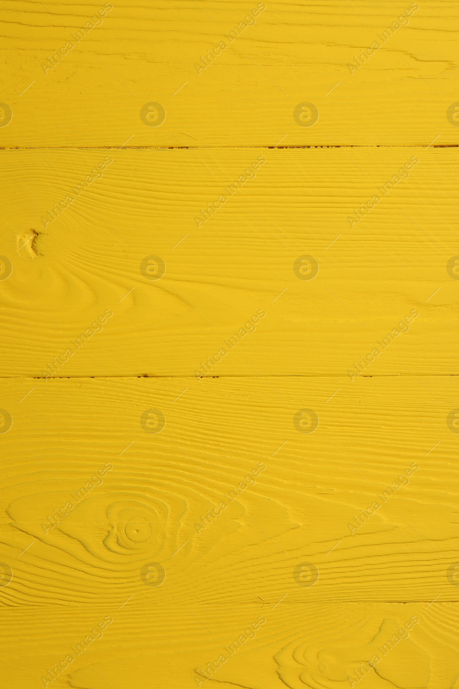 Photo of Texture of yellow wooden surface as background, closeup