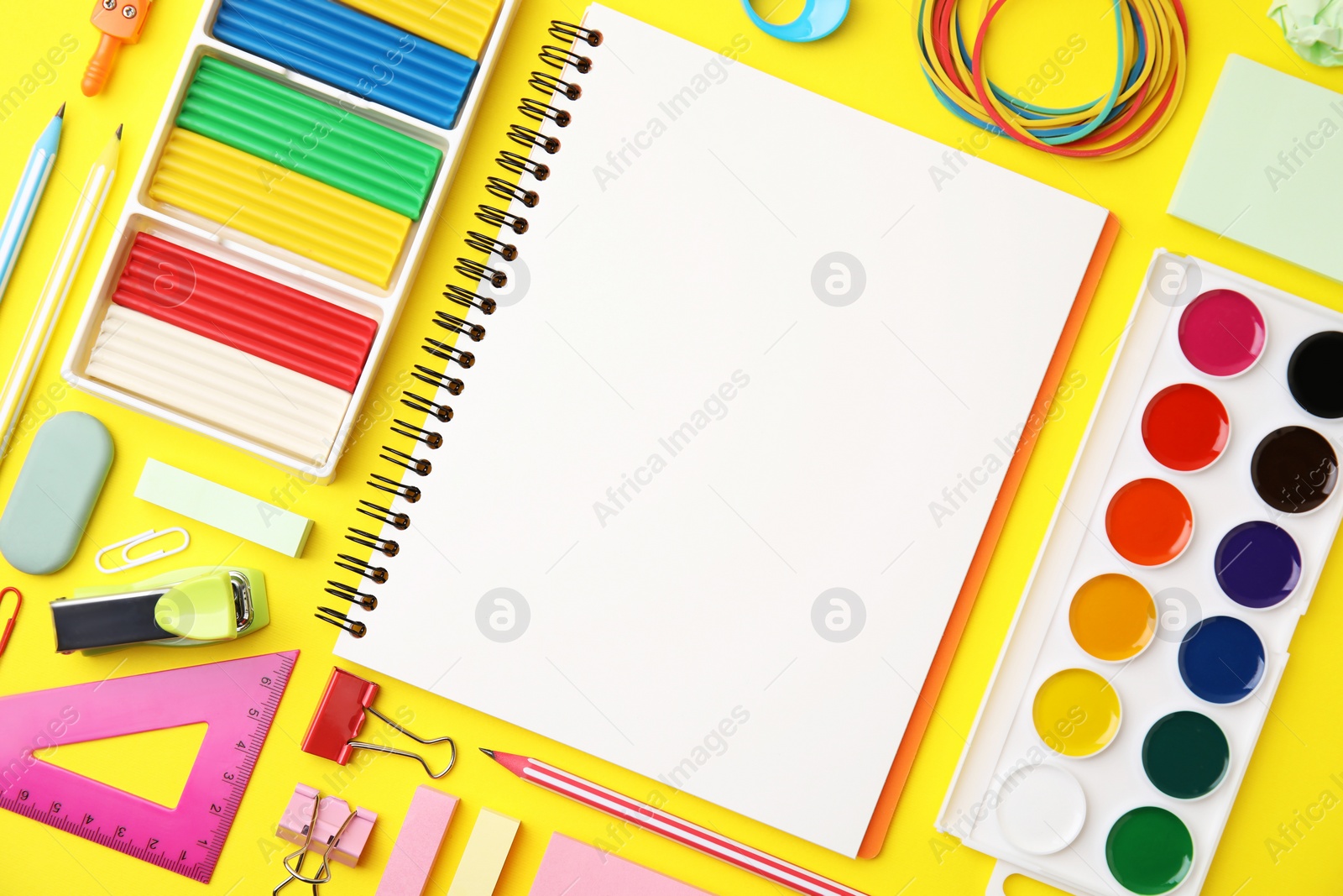 Photo of Flat lay composition with different school stationery on yellow background, space for text. Back to school