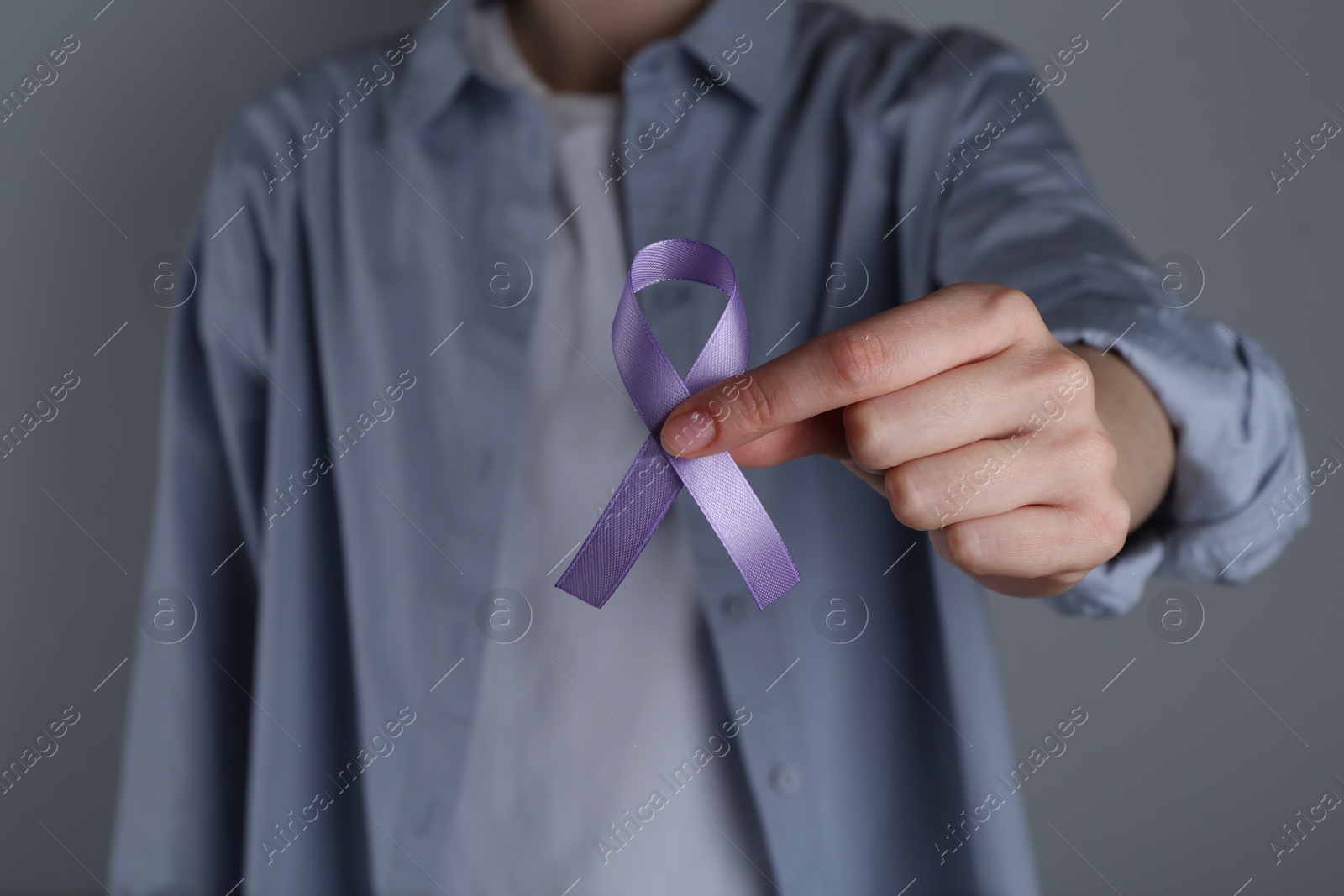 Photo of Woman with violet awareness ribbon on grey background, closeup