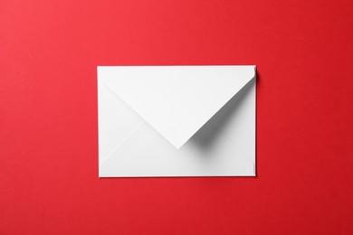 Photo of Letter envelope on red background, top view