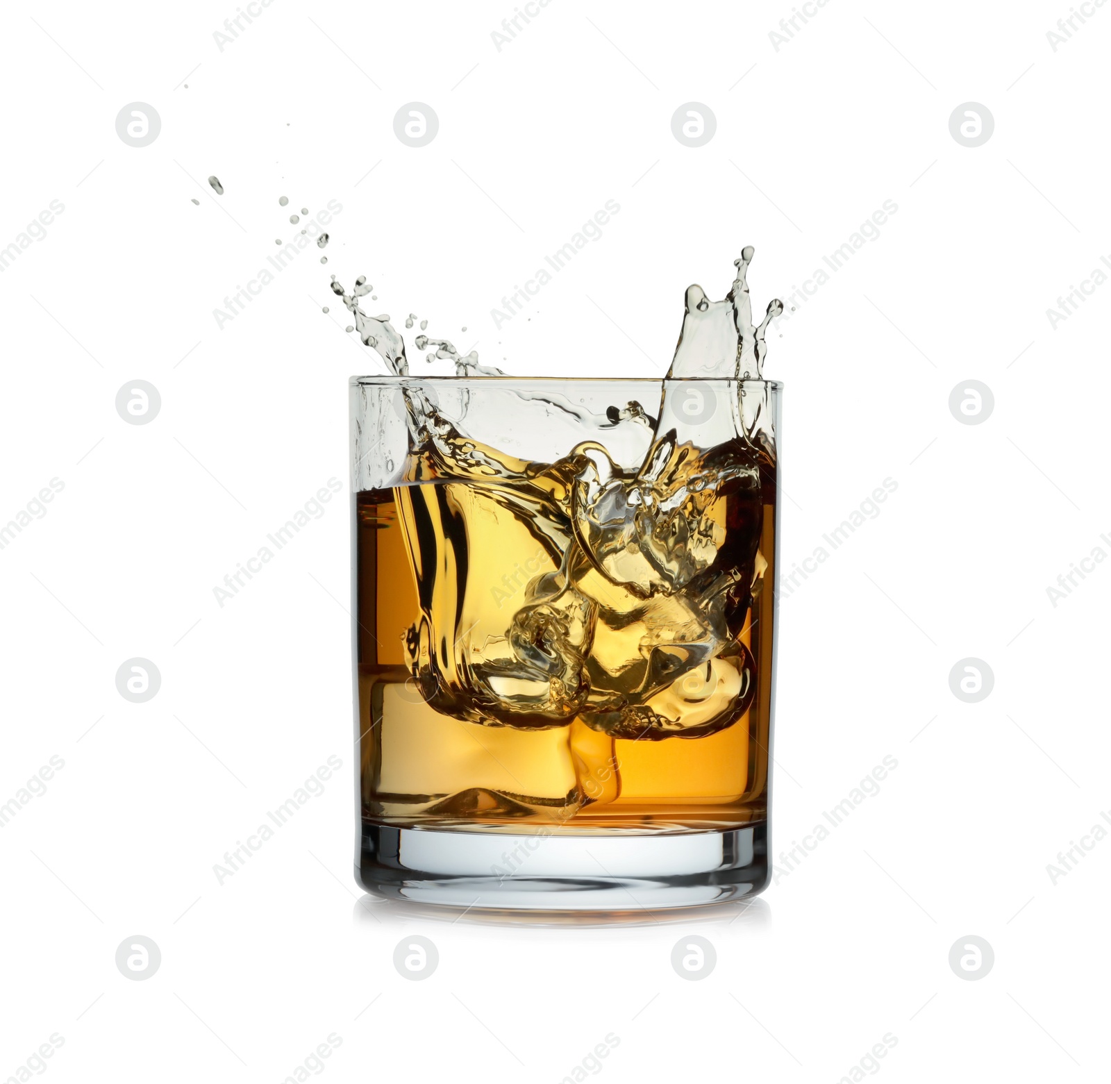 Photo of Whiskey splashing in glass isolated on white