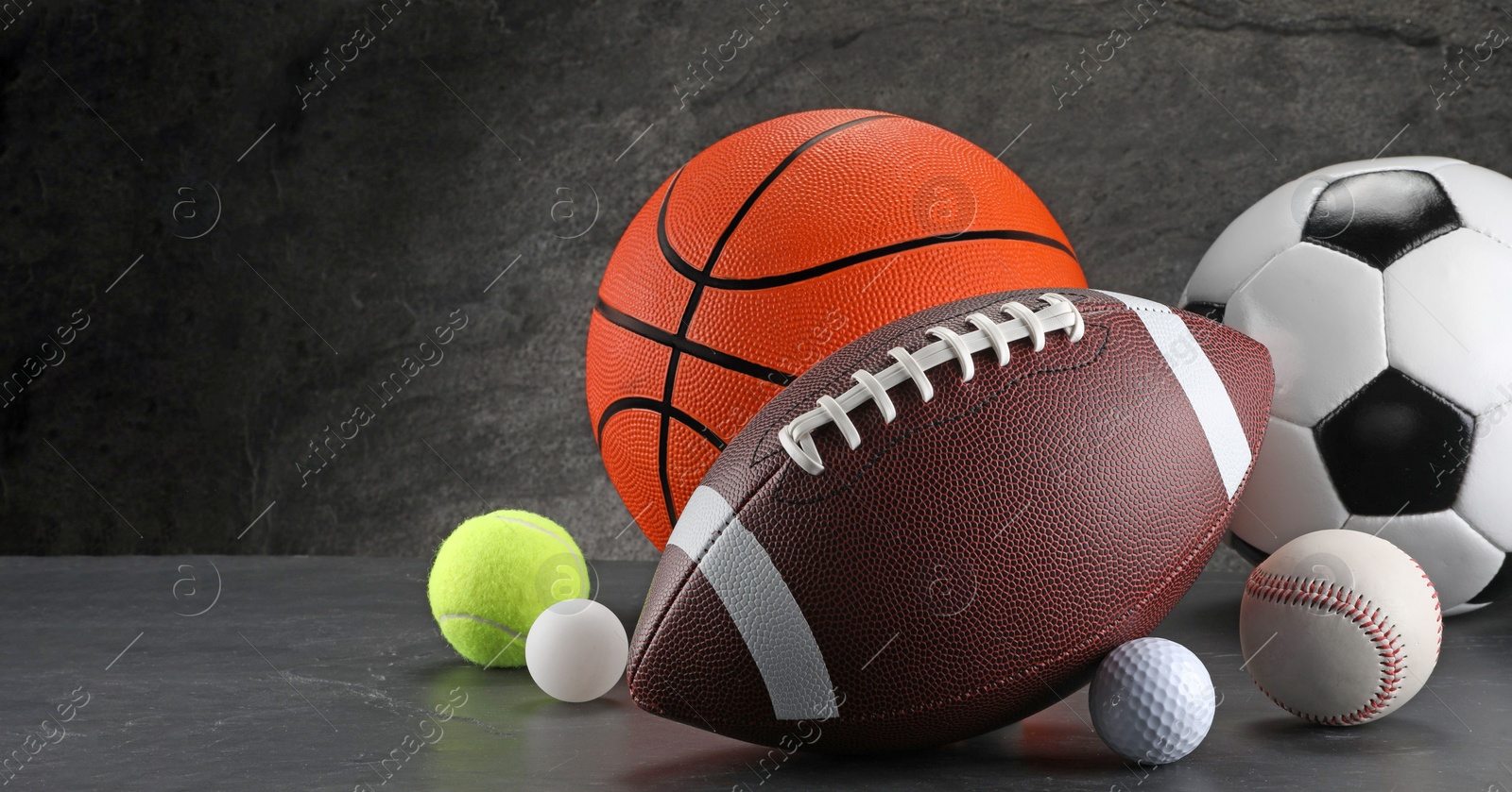 Photo of Many different sports balls on dark gray background, space for text. Banner design