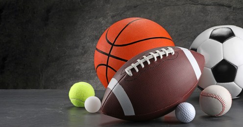 Photo of Many different sports balls on dark gray background, space for text. Banner design