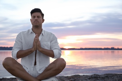 Photo of Man near river at sunset, space for text. Nature healing power