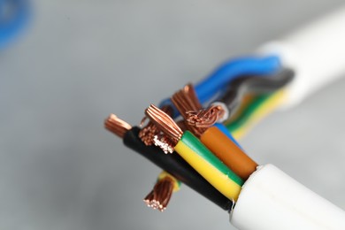 Colorful electrical wires on gray background, closeup