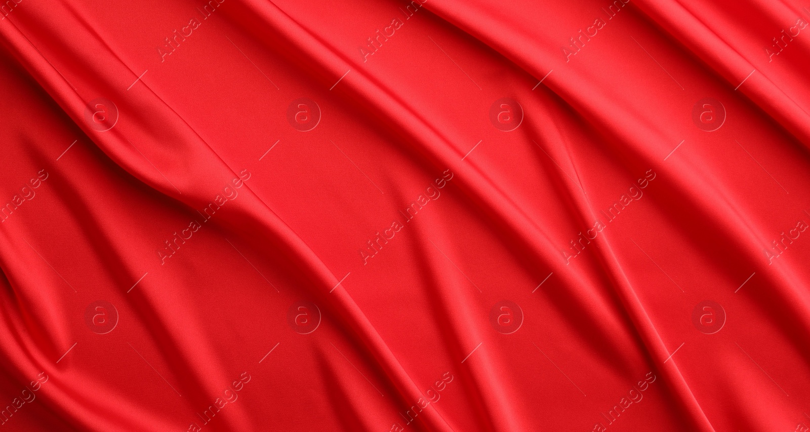 Photo of Crumpled red silk fabric as background, top view