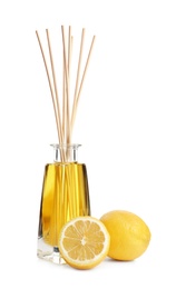 Photo of New reed air freshener and lemons on white background