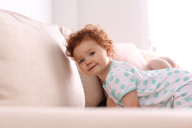 Photo of Portrait of cute little child on sofa at home