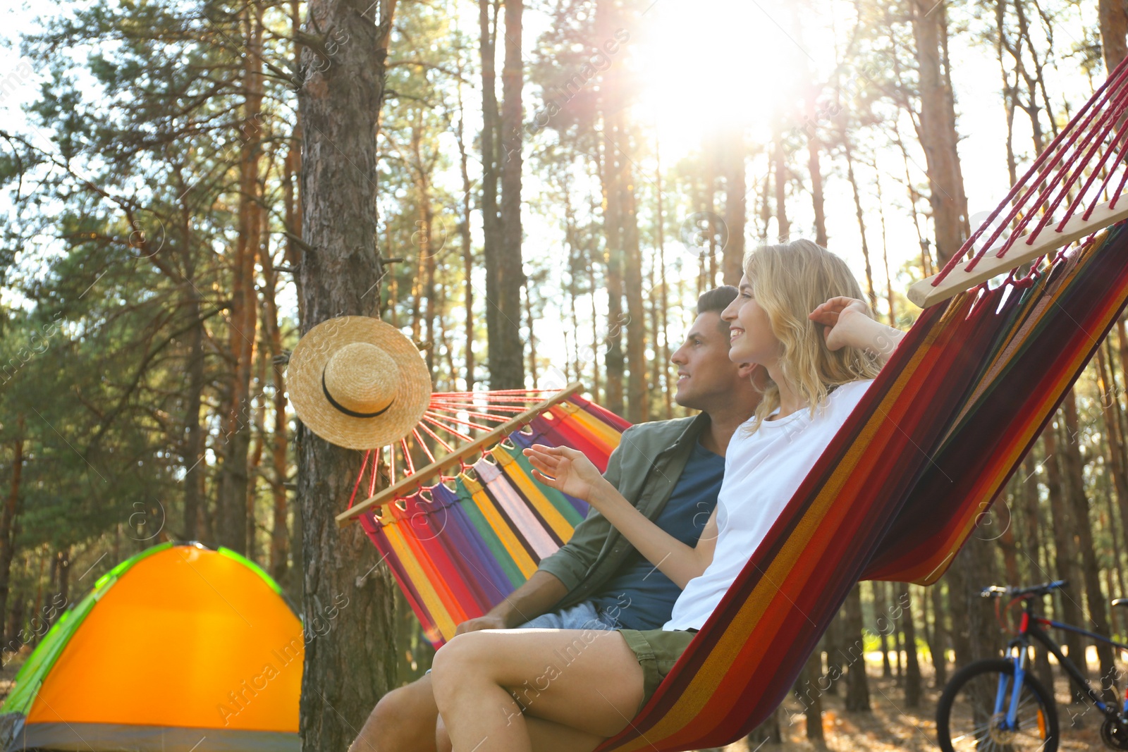 Photo of Couple resting in hammock outdoors on summer day