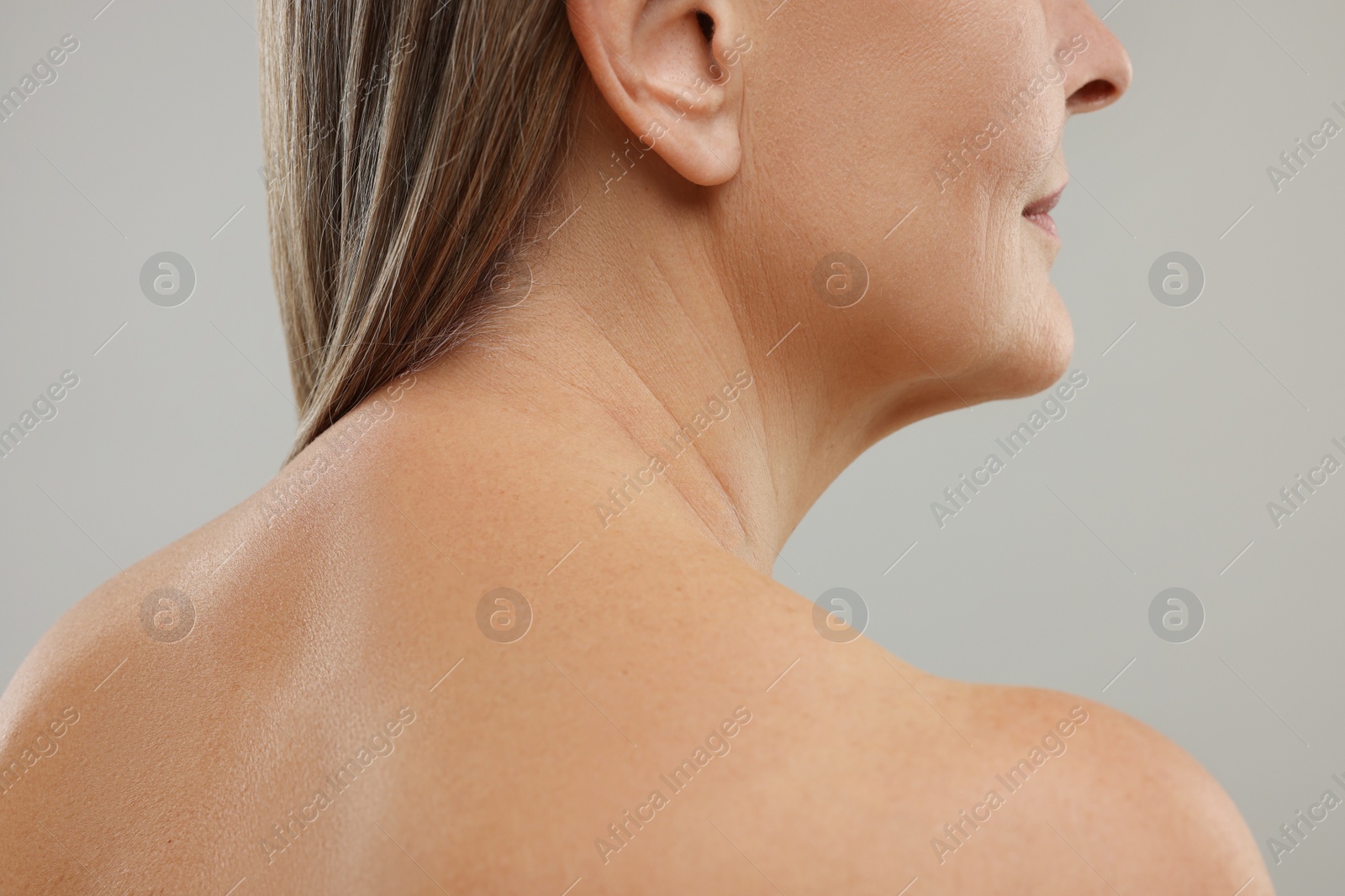 Photo of Mature woman with healthy skin on grey background, closeup