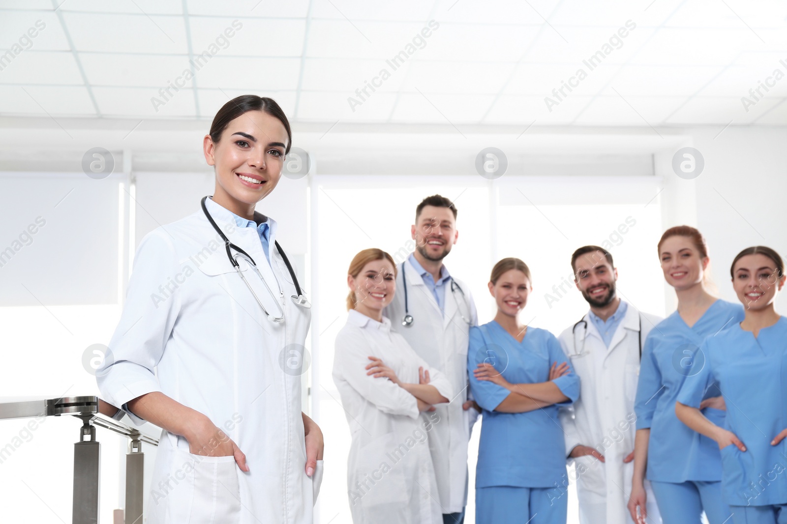 Photo of Young medical doctor with colleagues in clinic. Unity concept