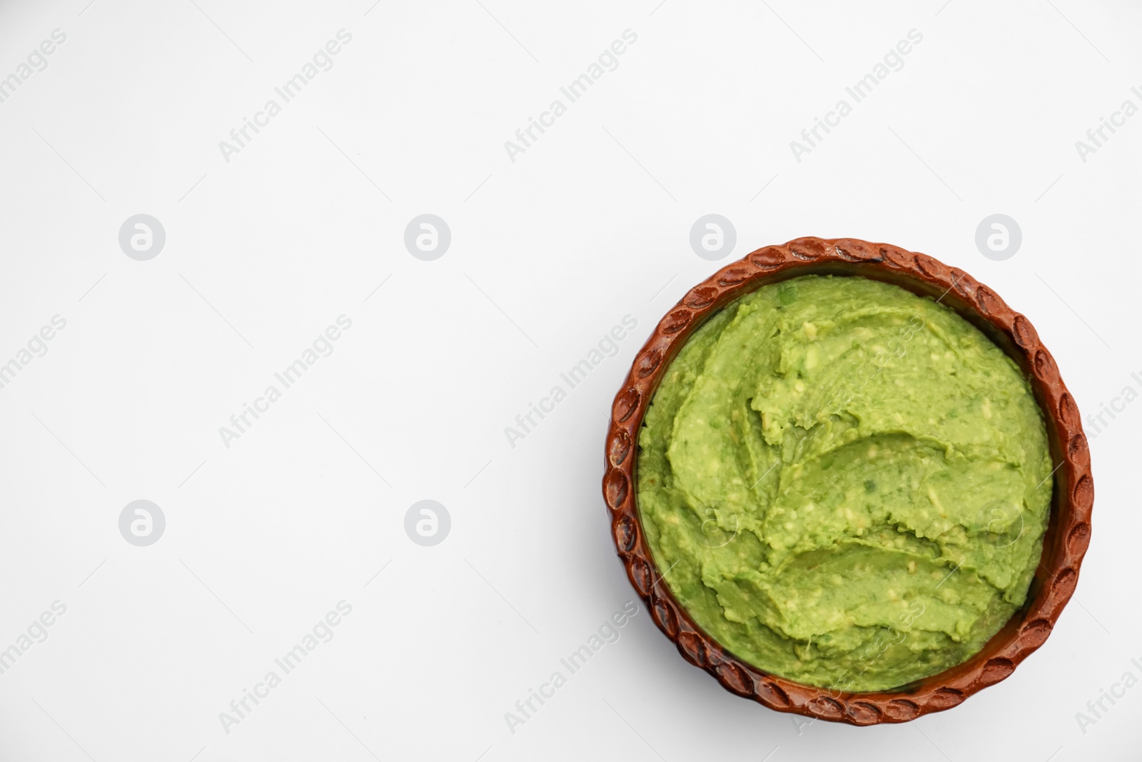 Photo of Delicious guacamole made of avocados on white background, top view. Space for text