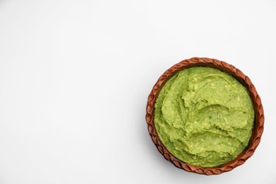 Photo of Delicious guacamole made of avocados on white background, top view. Space for text