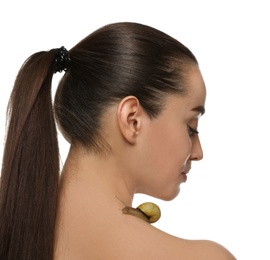 Beautiful young woman with snail on her neck against white background