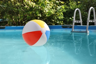 Photo of Inflatable ball on water in above ground swimming pool outdoors