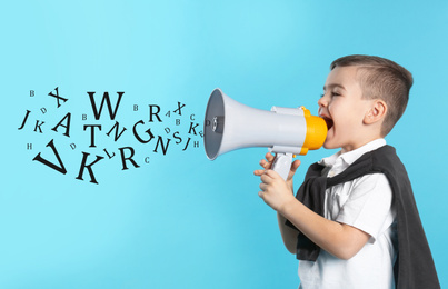 Image of Cute funny boy with megaphone and letters on light blue background. Speech therapy concept