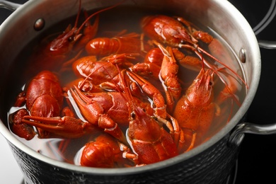 Photo of Fresh delicious crayfishes in pot, closeup view