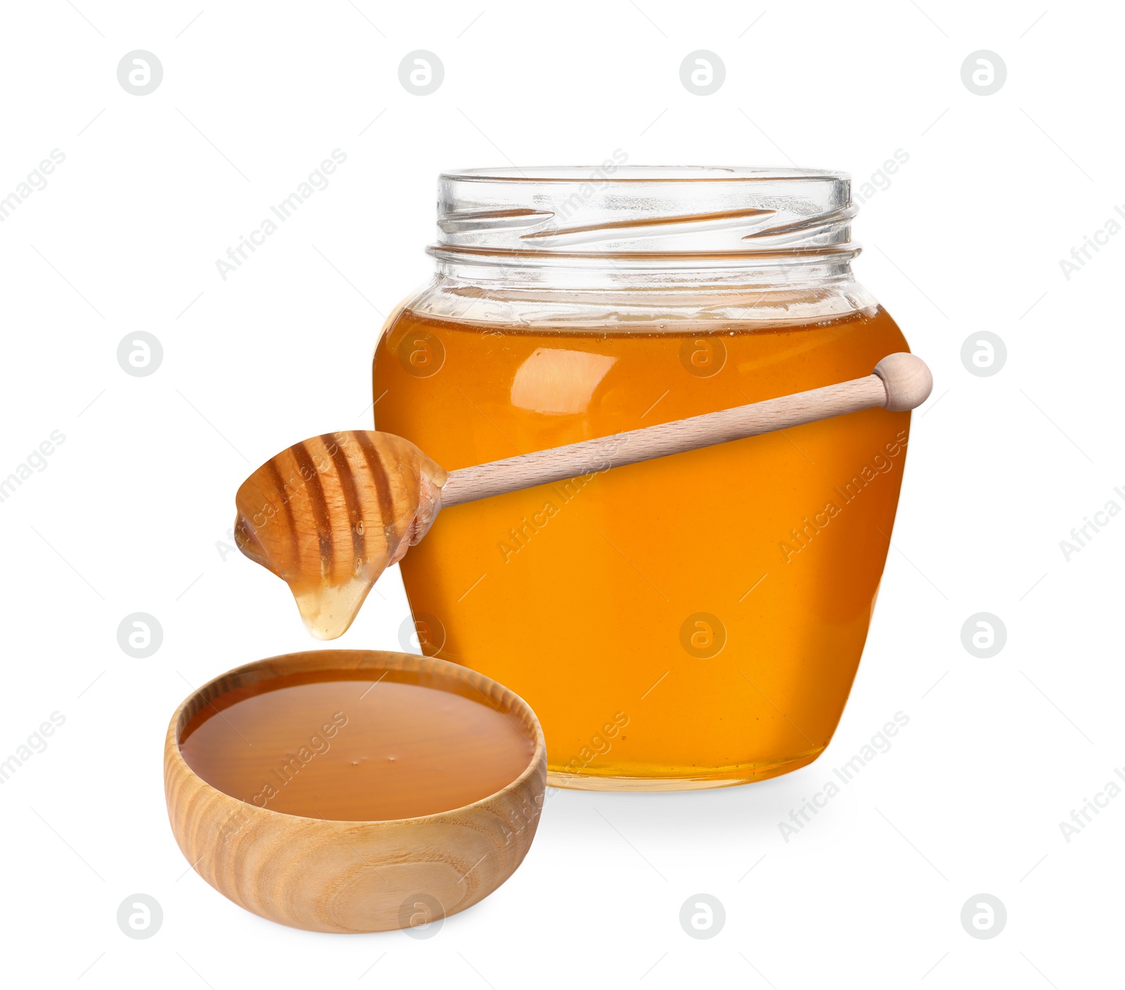 Image of Natural honey dripping from dipper into wooden bowl. Jar full of honey on white background