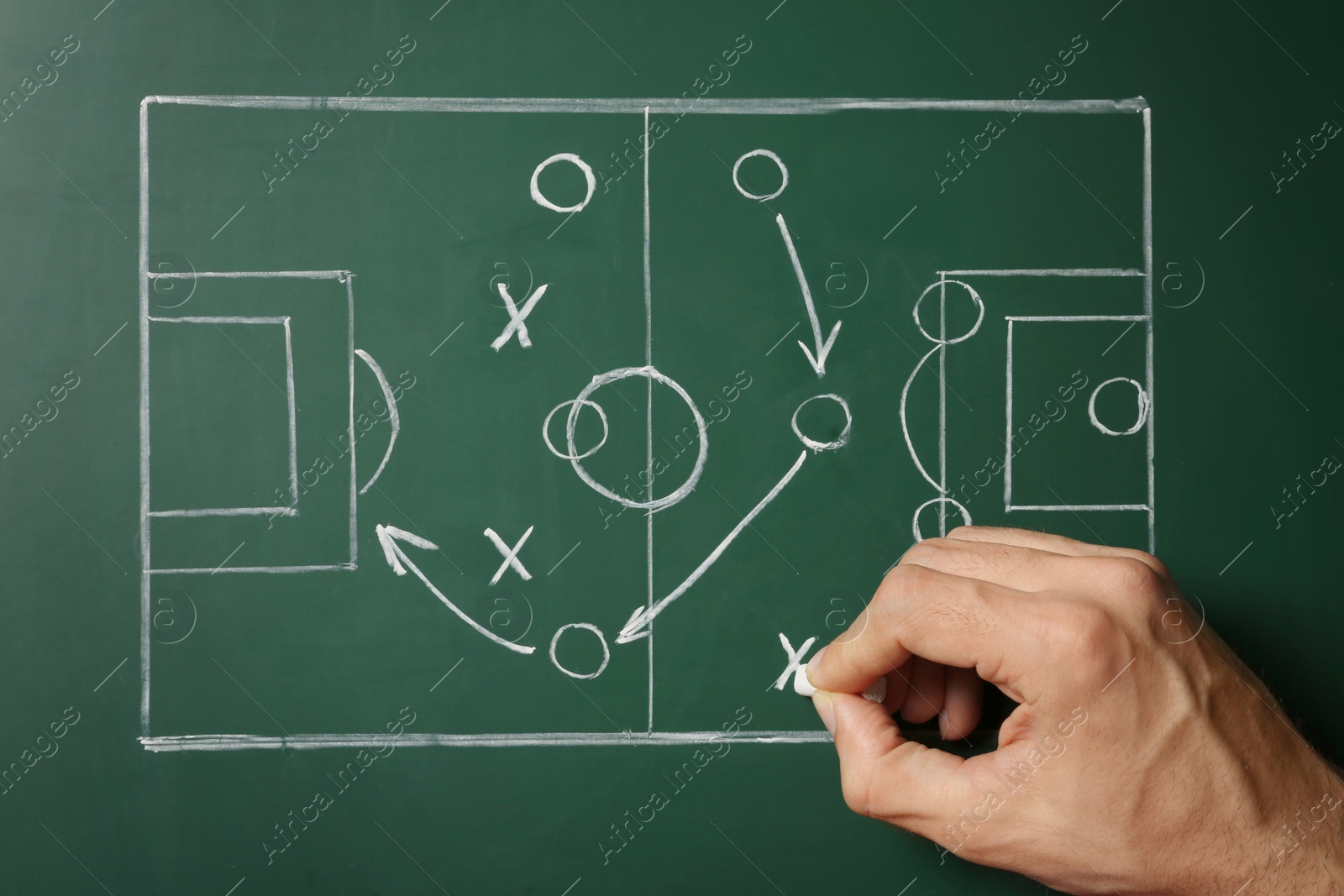 Photo of Man drawing football game scheme on chalkboard, top view