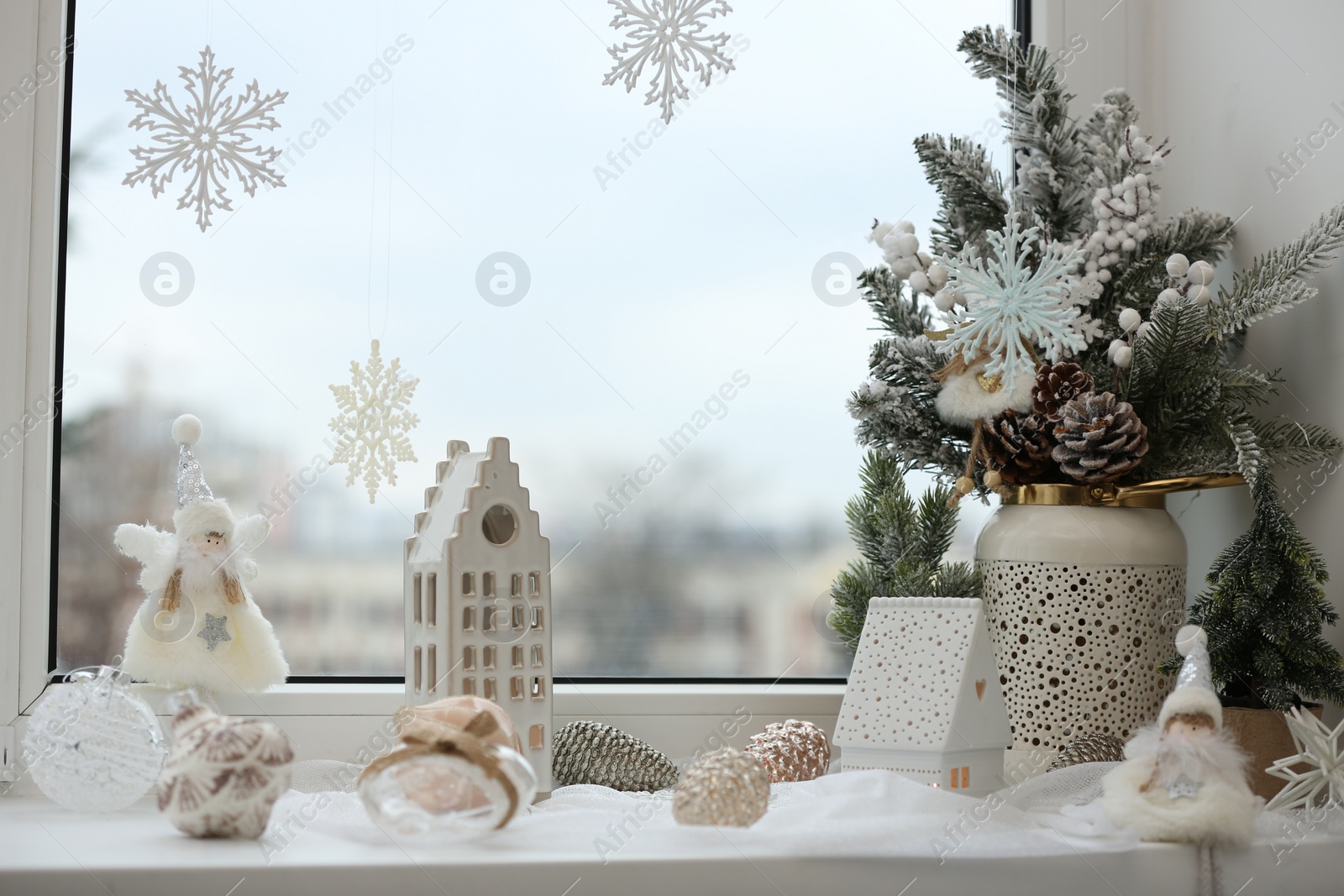 Photo of Many beautiful Christmas decorations on window sill indoors