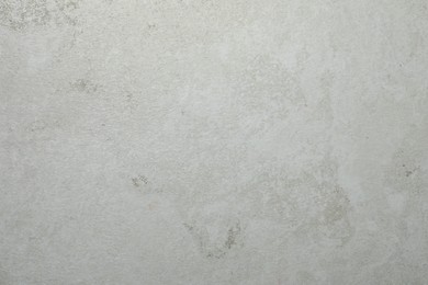 Photo of Texture of light grey stone surface as background, closeup