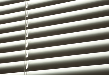 Closed modern white window blinds, closeup view