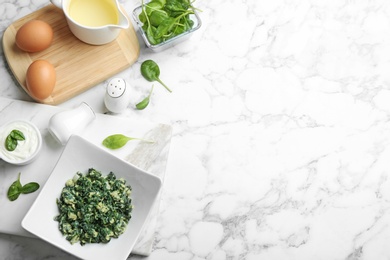 Photo of Flat lay composition with tasty spinach and space for text on white marble table. Healthy food